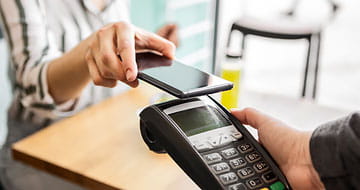 Woman making payment with her smart phone