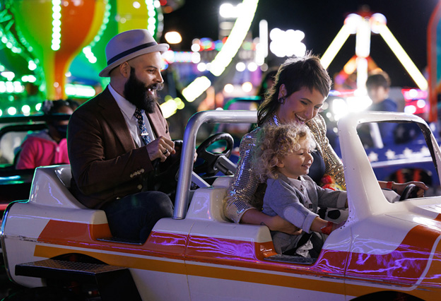 Family rides trucks at carnival