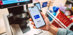 Customer holding a smart phone displaying a digital gift card