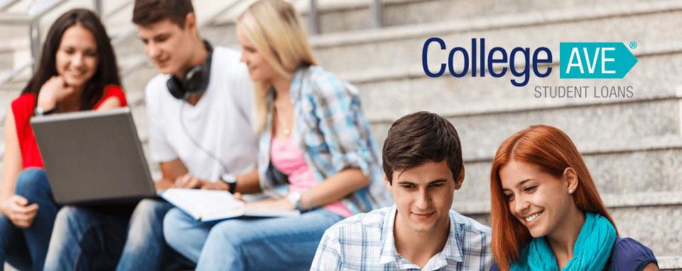 Group of university students seated on steps outdoors while using laptops