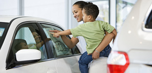 Woman and son looking at car's sticker price
