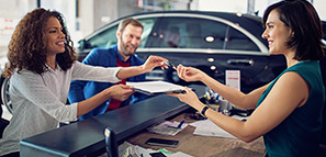 Couple signing the contract when buying a new car