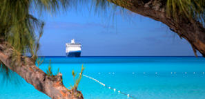 A ship waits on the horizon on a beautiful beach in the Caribbean