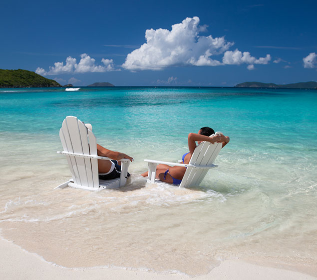 Couple seated in chairs on a Caribbean beach